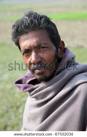 KUMROKHALI, INDIA - JANUARY 16: Portrait of an unidentified day laborer January 16, 2009 in Kumrokhali, West Bengal, India. These men sit on the street hoping to get day jobs not paid more than 2,5 dollars a day.