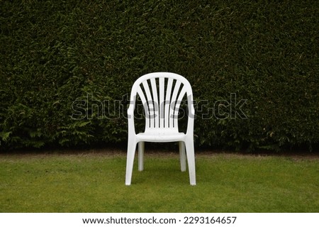 Image, Stock Photo White plastic garden bench stands on a meadow with yellow flowers