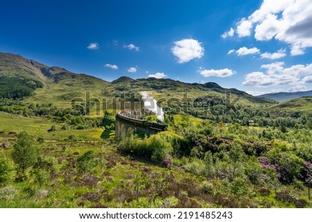 Glenfinnan Railway Viaduct in Scotland with the steam train passing over Сток-фото © 