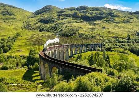 Glenfinnan Railway Viaduct in Scotland with the steam train passing over Сток-фото © 