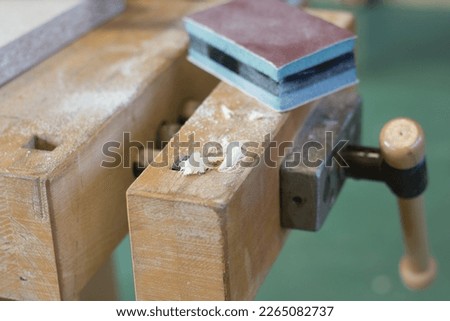 Similar – Image, Stock Photo Plain wooden bench in front of a wooden wall, with a window barricaded with square timbers.