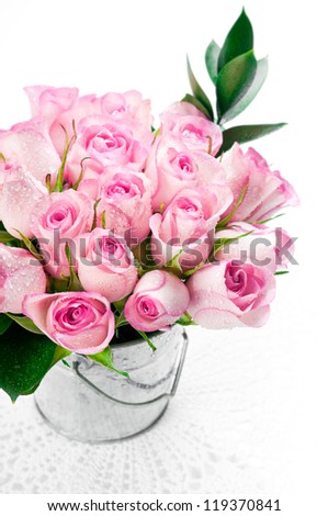 Pink rose bouquet in a bucket on a white background