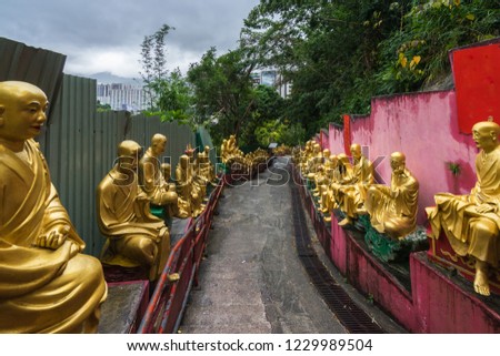 Steep walkway descending form Ten Thousand Buddhas Monastery surrounded by golden Buddha statues, Hong Kong, Sha Tin, New Territories Stok fotoğraf © 