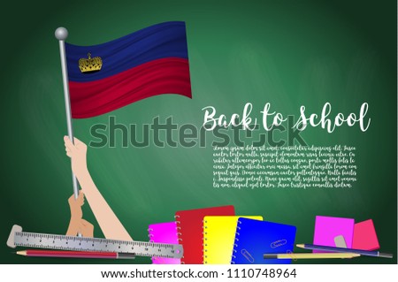 Vector flag of Liechtenstein on Black chalkboard background. Education Background with Hands Holding Up of Liechtenstein flag. Back to school with pencils, books, school items learning and childhood