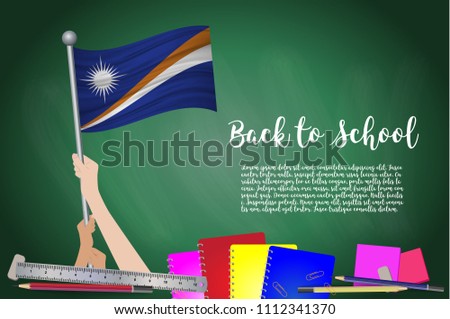 Vector flag of Marshall on Black chalkboard background. Education Background with Hands Holding Up of Marshall flag. Back to school with pencils, books, school items learning and childhood concept.