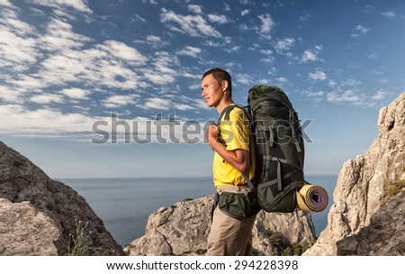 Backpacker looking at sky from rocks