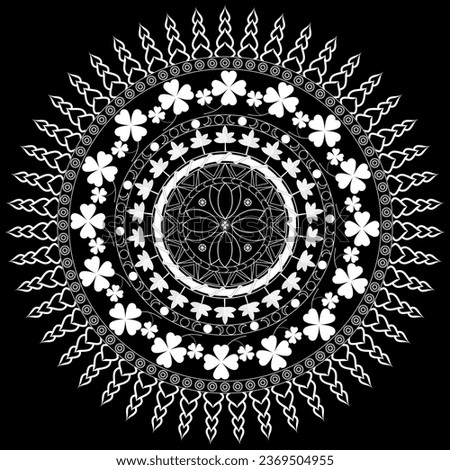 Mandala with four-leaf clover and autumn leaf in white lines on a black background.