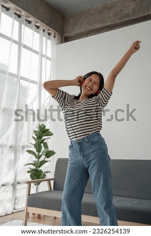 Similar – Foto Bild Asiatische Frau hört Musik in der Nähe einer rauen Wand