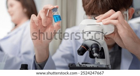 Image, Stock Photo Focused scientist examining chemical solution in laboratory