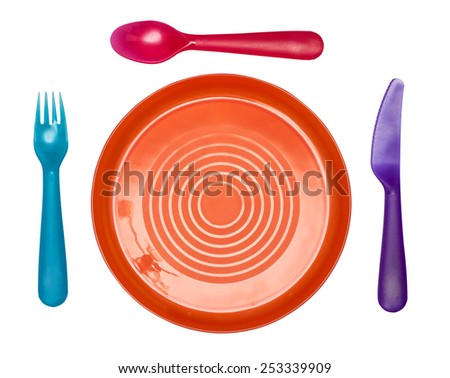 Plastic ware: a orange plate, a blue fork, a red spoon, the violet knife isolated on the white
