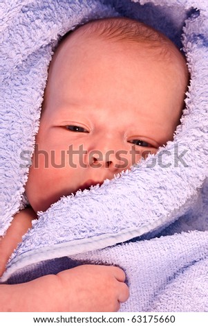 The kid who has been wrapped up after bathing