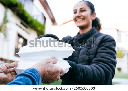 Similar – Image, Stock Photo Female volunteer delivering bags with shopping to elderly woman during coronavirus pandemic