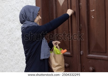 Similar – Image, Stock Photo Female volunteer delivering bags with shopping to elderly woman during coronavirus pandemic