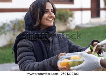 Similar – Image, Stock Photo Female volunteer delivering bags with shopping to elderly woman during coronavirus pandemic