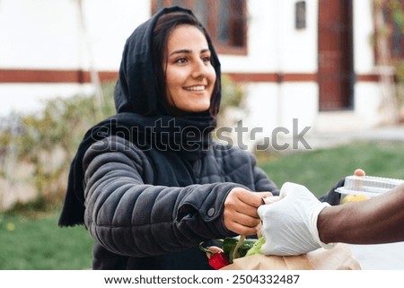 Similar – Image, Stock Photo Female volunteer delivering bags with shopping to elderly woman during coronavirus pandemic