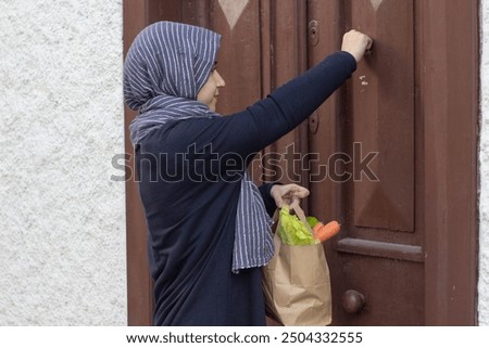 Similar – Image, Stock Photo Female volunteer delivering bags with shopping to elderly woman during coronavirus pandemic