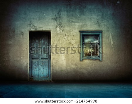 dark vintage interior with blue wooden door and window with sky above at night