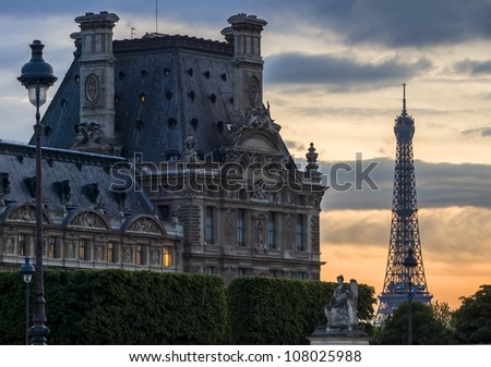 PARIS-APRIL 29: Right wing of Louvre Museum and Eiffel Tower at dusk on April 29, 2009, Paris, France. These famous landmarks are most visited museums in world with about 6 million visitors every year