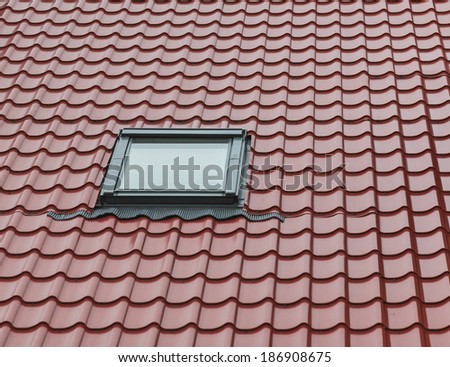 Background of tiled red roof with glassy window