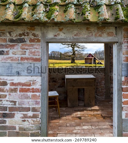 Rustic landscape with old oak and bath house seen through window of old abandoned building
