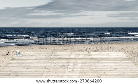 Wooden deck floor over of sand beach of the Baltic Sea. Image toned for inspiration of retro style