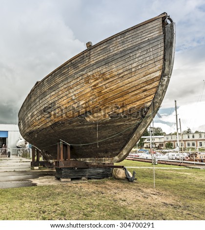 Old wooden boat intended for fisheries in open seas, Beach of the Baltic Sea in region of the Kurzeme, Latvia
