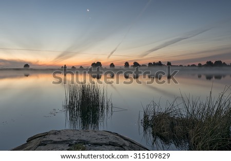 Riverside before sunrise with crescent moon and Pole star on the sky