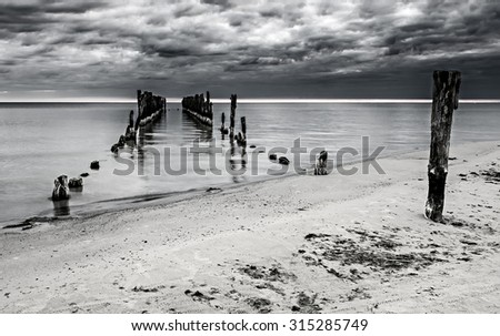 Coastal landscape with old broken pier, Baltic Sea. Image was filtered for inspiration of vintage style