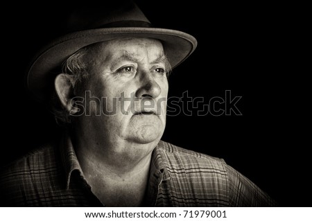 photo senior male retired wearing a hat on black