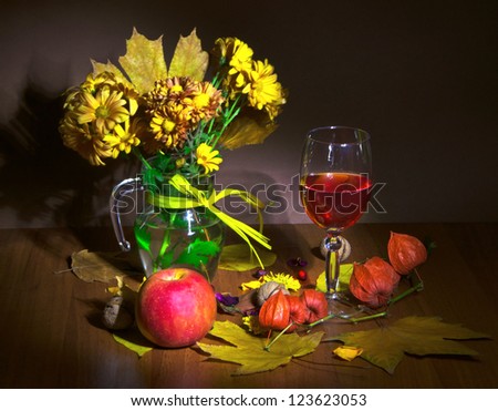 autumn bouquet and wine in glass with fruit and nut