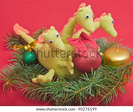 christmas decorations as dragon with ball on red