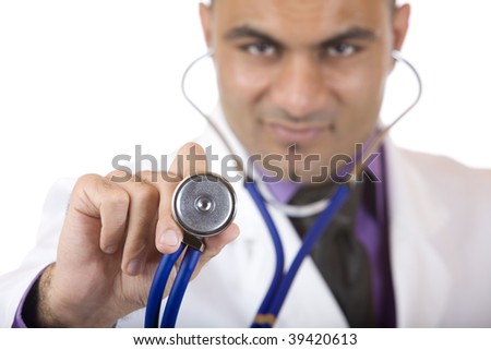 Medical doctor is standing and holding a stethoscope in front of him, in order to make a examination. Isolated on white focus on stethoscope.