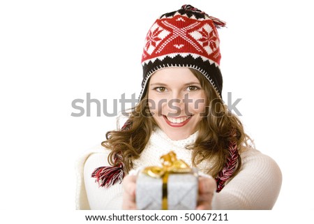 Young women in Santa Claus dress is holding a Christmas present in her hands. Isolated on white.