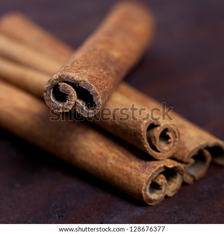 Cinnamon sticks, shot close-up on the table. Selective focus limited to edges of closest sticks