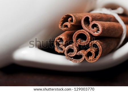 Cinnamon sticks, shot close-up on the table. Selective focus limited to edges of closest sticks