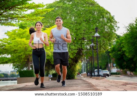 Couples who take care of their health by exercising happily in the city. Health care concept Foto stock © 