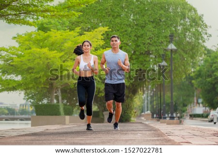 Couples who take care of their health by exercising happily in the city. Health care concept Foto stock © 