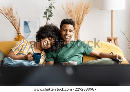 Similar – Image, Stock Photo Diverse couple chilling on floats