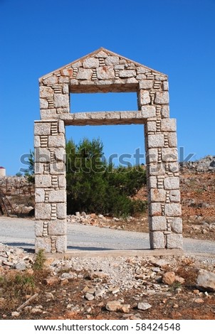 Stone doorway at the entrance to the five a side football stadium at Emborio on the Greek island of Halki.