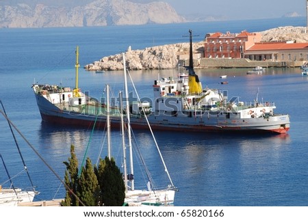 EMBORIO, GREECE - JUNE 5: The water tanker  ship Olympic departs from Emborio harbour on June 5, 2010 at Halki island, Greece. Like many Greek islands, Halki relies on regular deliveries of water.
