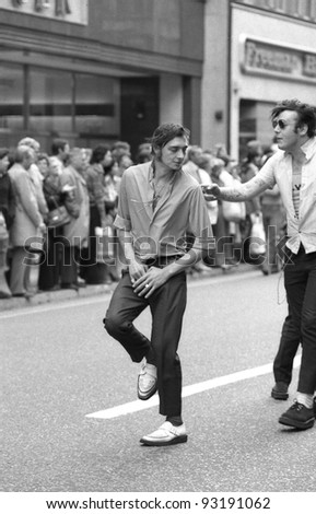 LONDON - MAY 15: Unidentified music fans take part in the Rock 'n' Roll Radio Campaign march on May 15, 1976 in London, England. The campaign aims to get more vintage  Rock 'n' Roll music played on British radio.