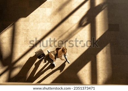 Similar – Image, Stock Photo Blurred people walking in a large tunnel of a train station. The New Normal. A group of people rushing through a subway corridor.