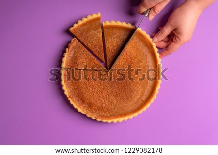 Similar – Image, Stock Photo Pumpkin pie home-baked, above view. Sliced pie isolated on a colorful background