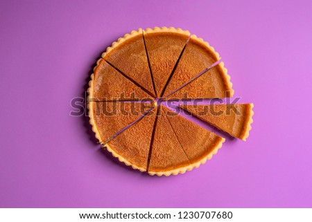 Similar – Image, Stock Photo Pumpkin pie home-baked, above view. Sliced pie isolated on a colorful background