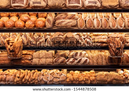 Delicious loaves of bread in a german baker shop. Different types of bread loaves on bakery shelves.