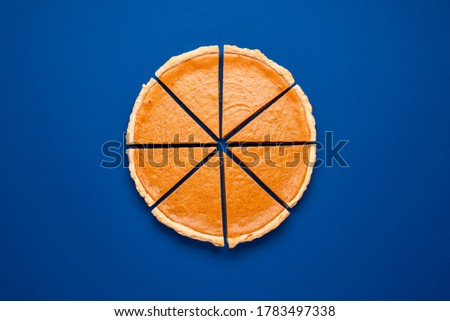 Similar – Image, Stock Photo Pumpkin pie home-baked, above view. Sliced pie isolated on a colorful background