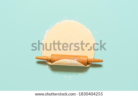Similar – Image, Stock Photo Dough rolled out on a green background. Homemade pie crust and rolling pin. Baking concept