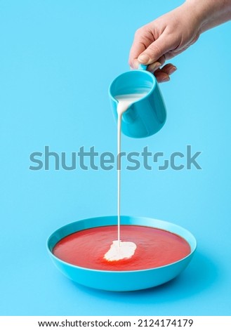 Similar – Image, Stock Photo Pouring cream in tomato soup minimalist on a blue background