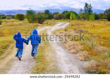 girl and boy standing or running on the road