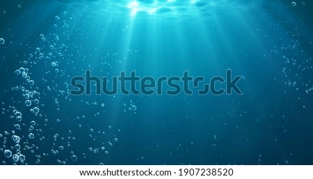 Underwater background with water bubbles and undersea light rays shine